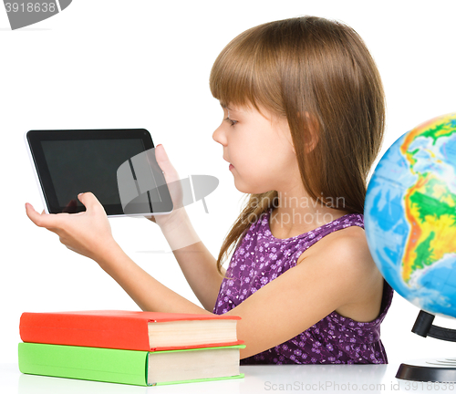 Image of Young girl is showing tablet