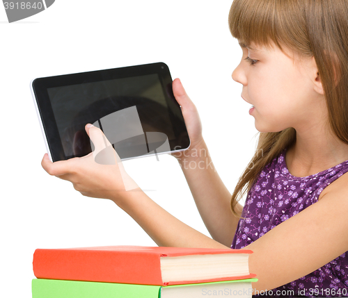 Image of Young girl is showing tablet