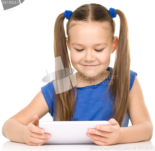 Image of Young girl is using tablet