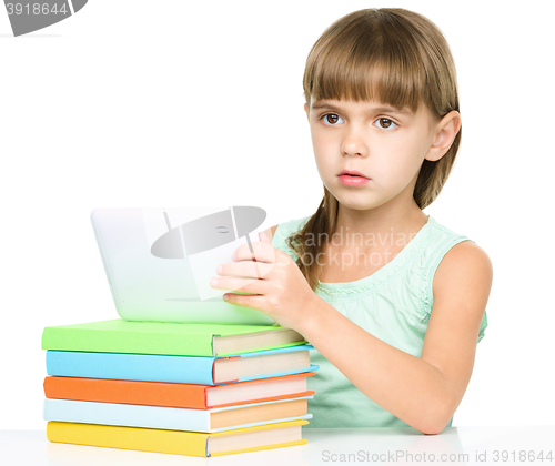 Image of Young girl is using tablet