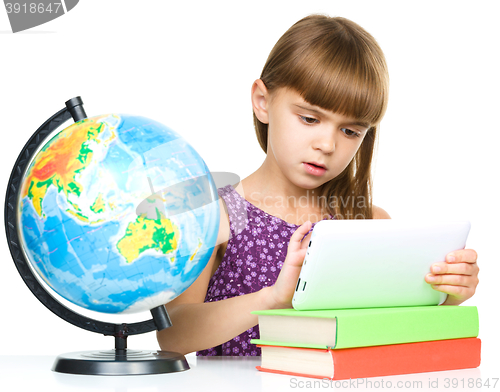 Image of Young girl is using tablet