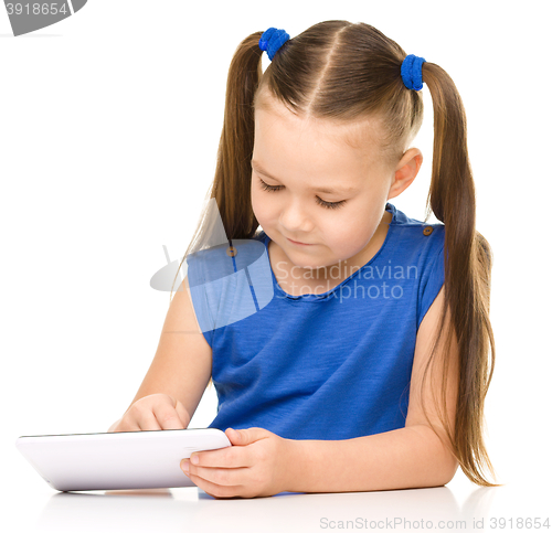 Image of Young girl is using tablet