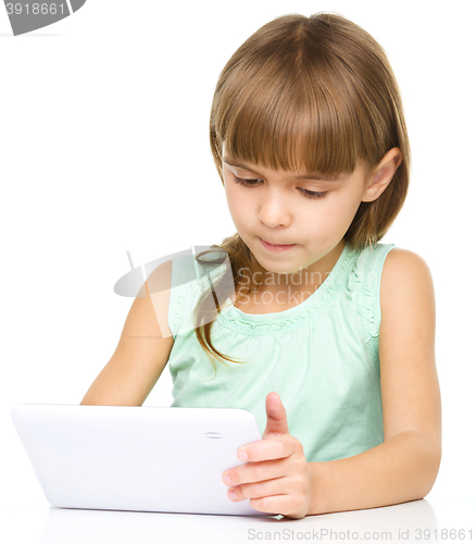 Image of Young girl is using tablet