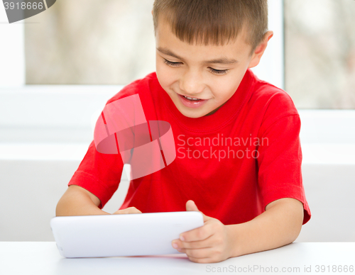 Image of Young boy is using tablet