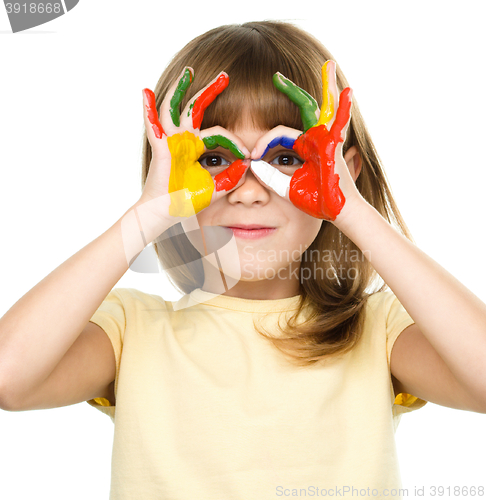 Image of Portrait of a cute girl playing with paints