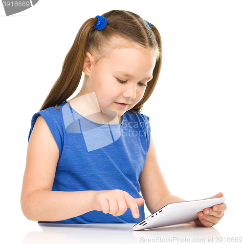 Image of Young cheerful girl is using tablet