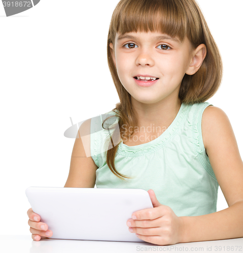 Image of Young girl is using tablet