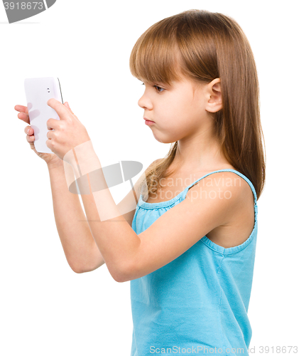 Image of Young girl is using tablet