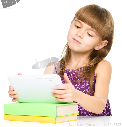 Image of Young girl is using tablet