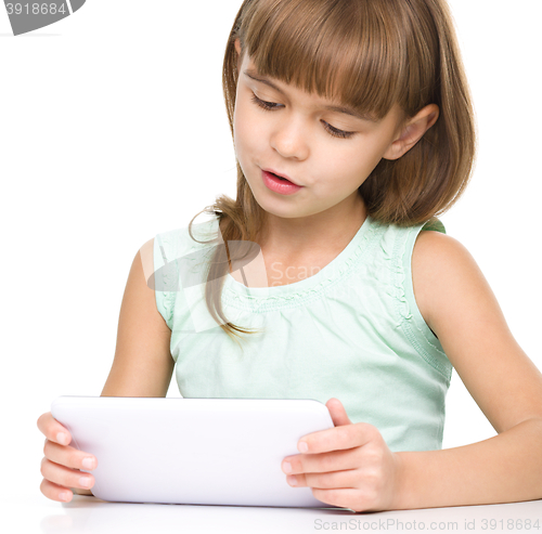 Image of Young girl is using tablet