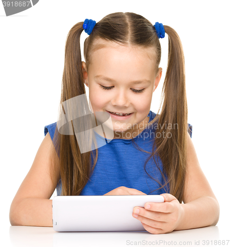 Image of Young girl is using tablet