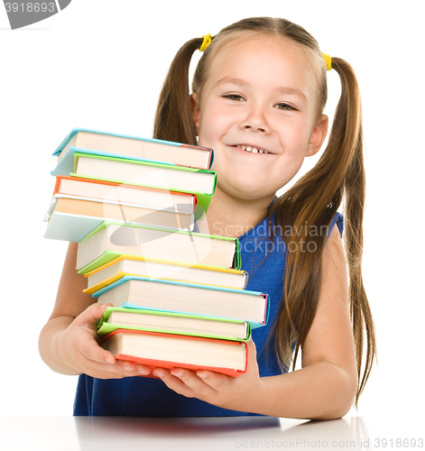 Image of Little girl with books