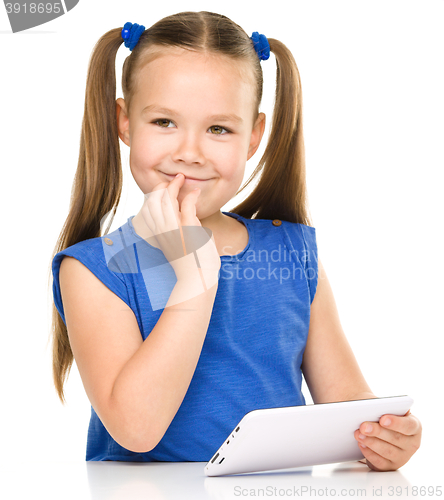 Image of Young girl is using tablet