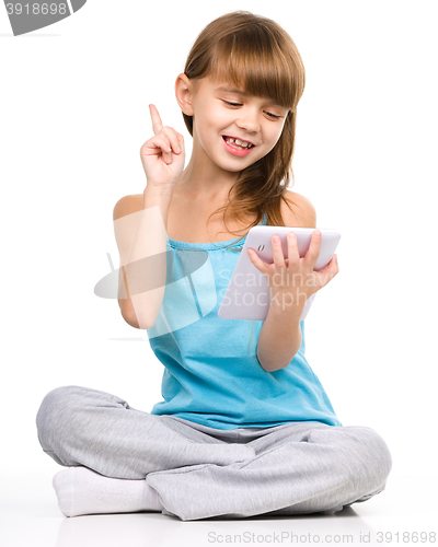 Image of Young girl is using tablet