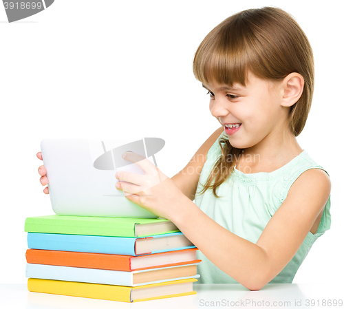 Image of Young girl is using tablet