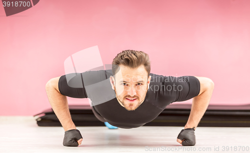 Image of Portrait of a Young Man Doing Pushups