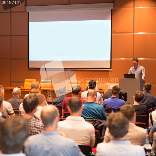 Image of Business speaker giving a talk in conference hall.