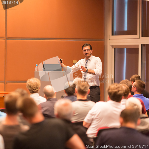 Image of Business speaker giving a talk in conference hall.