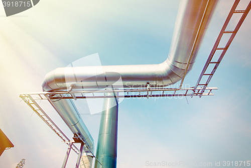 Image of Industrial zone, Steel pipe-lines on blue sky