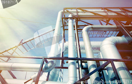 Image of Industrial zone, Steel pipelines and valves against blue sky