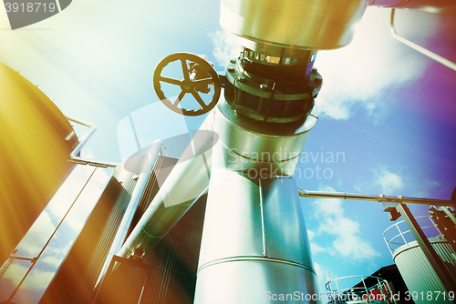 Image of Industrial zone, Steel pipelines and valves against blue sky