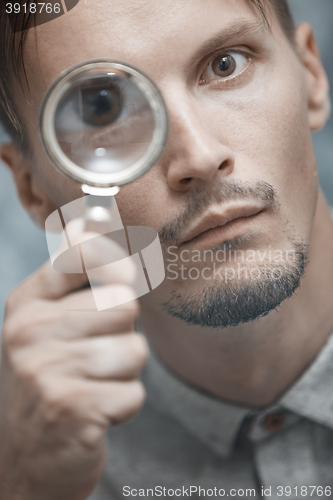 Image of Man with magnifying glass