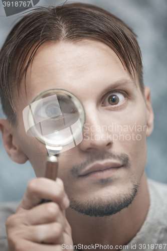 Image of Man with magnifying glass