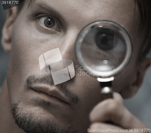 Image of Man with magnifying glass