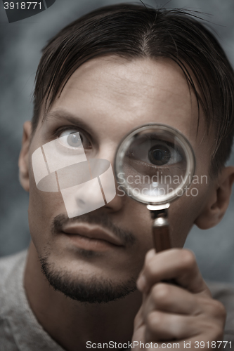 Image of Man with magnifying glass