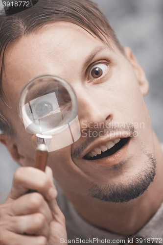 Image of Man with magnifying glass