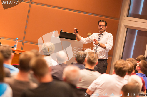 Image of Business speaker giving a talk in conference hall.