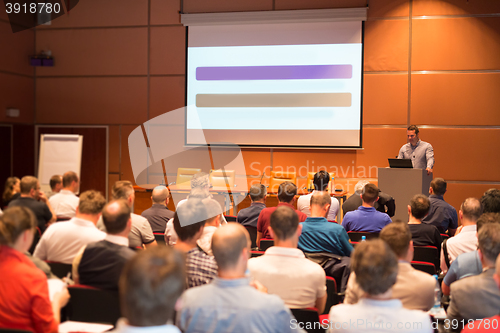 Image of Business speaker giving a talk in conference hall.