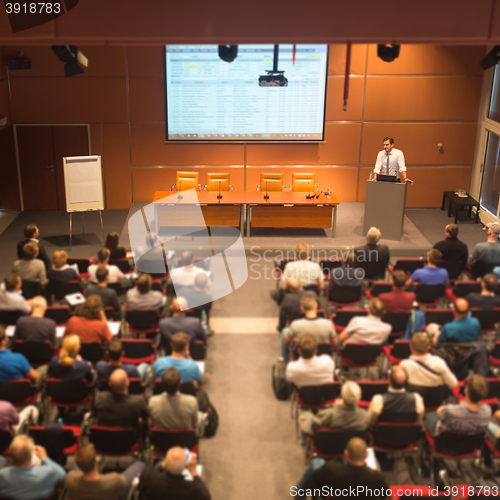 Image of Business speaker giving a talk in conference hall.