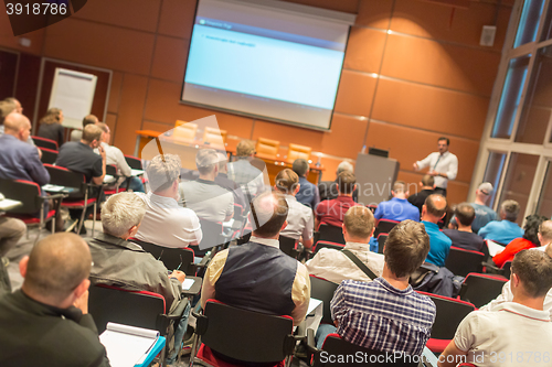 Image of Business speaker giving a talk in conference hall.