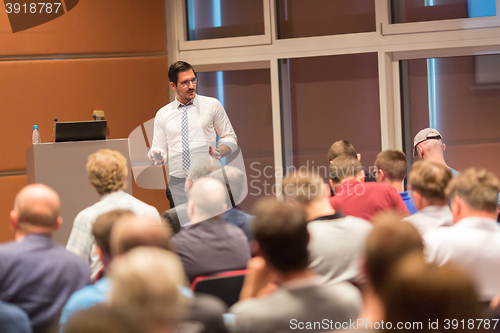 Image of Business speaker giving a talk in conference hall.