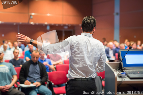 Image of Public speaker giving talk at Business Event.