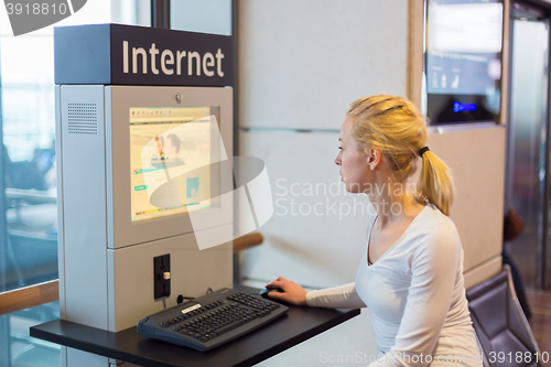 Image of Woman public internet access point on airport.