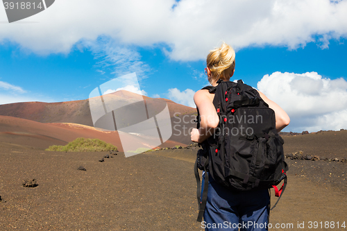 Image of Woman tracking to top of mountain.