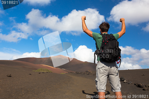 Image of Man reaching the top of mountain.