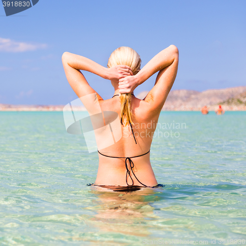 Image of Young woman enjoying summer swim.