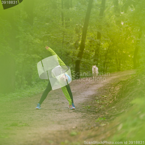Image of Sporty woman  working out in forest. 