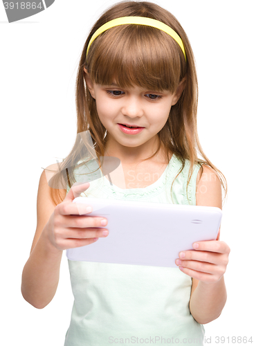 Image of Young girl is using tablet