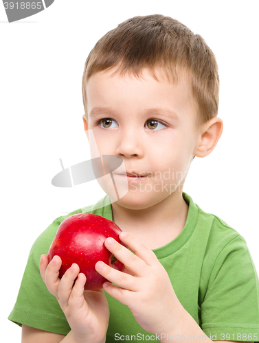 Image of Portrait of a cute little boy with red apple