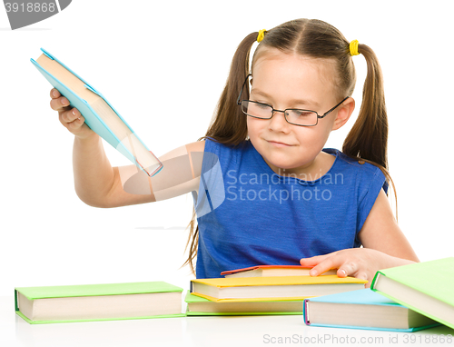 Image of Little girl is reading a book