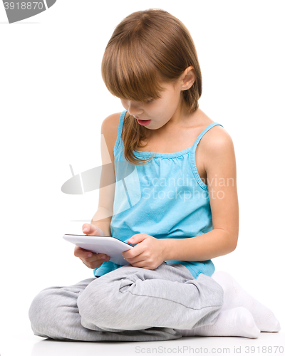 Image of Young girl is using tablet