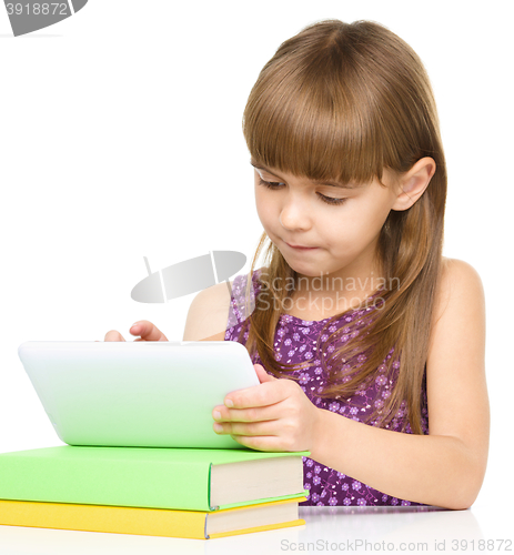 Image of Young girl is using tablet