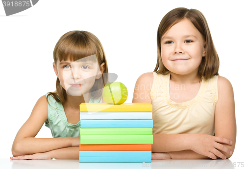 Image of Little girls with books and apple