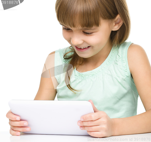Image of Young girl is using tablet
