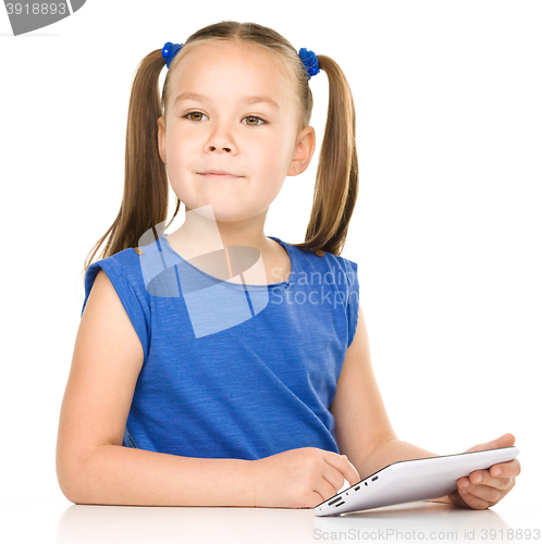 Image of Young girl is using tablet