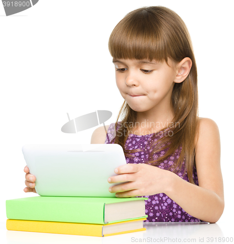 Image of Young girl is using tablet